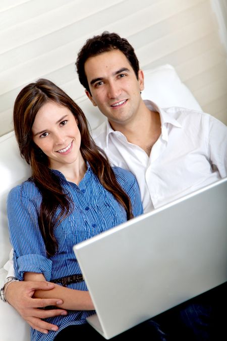 Couple at home working on a laptop