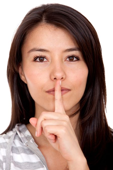 Woman making a keep it quiet gesture isolated over white