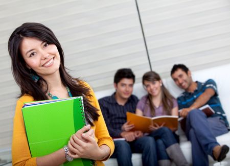Beautiful female student smiling with a group behind