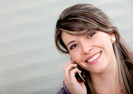 Beautiful girl talking on the phone and smiling