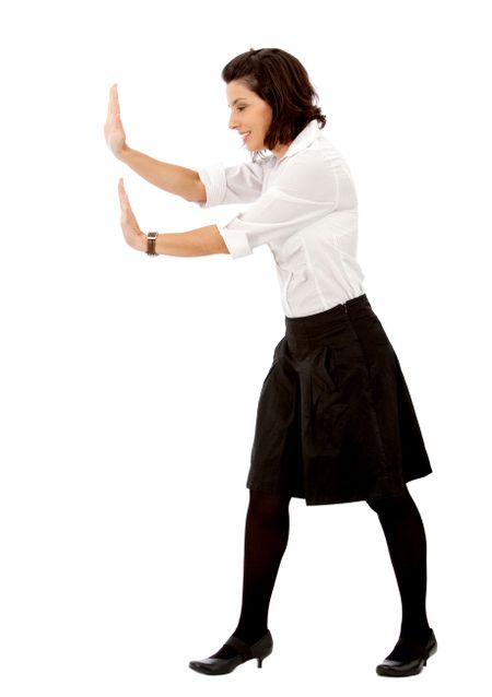 Business woman pushing something imaginary isolated over a white background