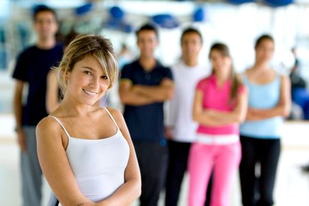 Woman at the gym with a group behind her