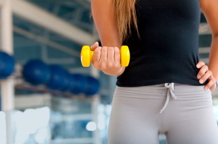 Woman torso at the gym with a free weight