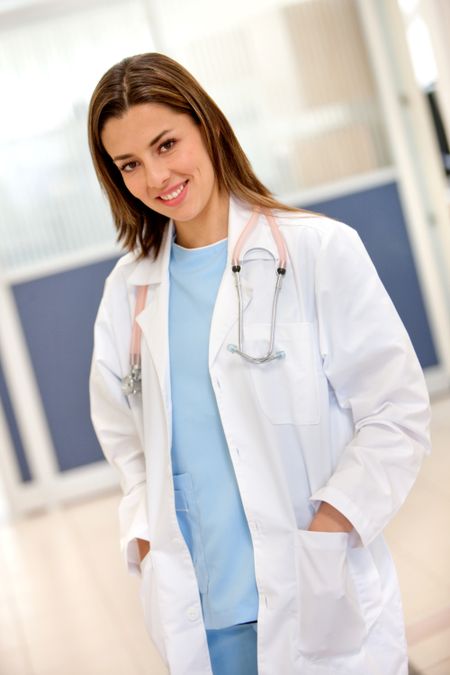 Beautiful female doctor looking happy indoors