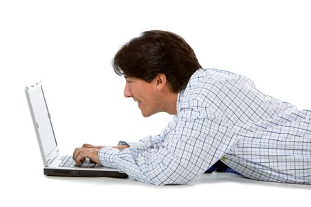 Man lying on the floor with a laptop isolated over a white background