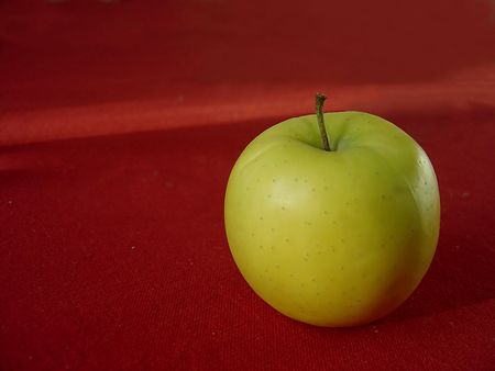Apple in green with red background