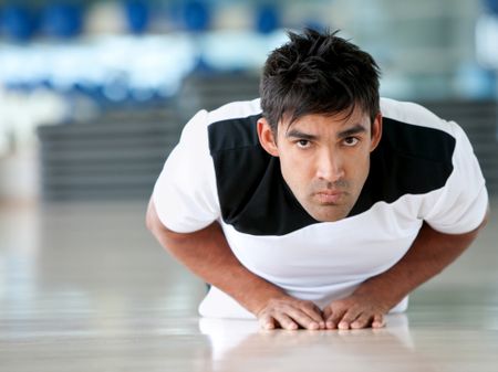 Handsome man doing exercise at the gym