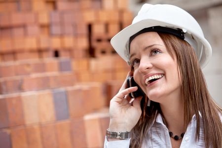 Female engineer on the phone at a construction site