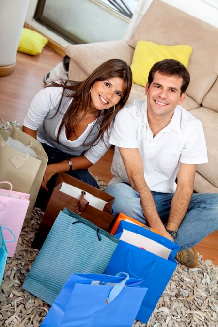Shopping couple at home looking at their purchases