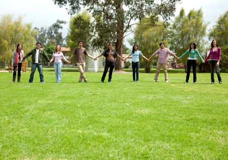 Group of casual people outdoors holding hands