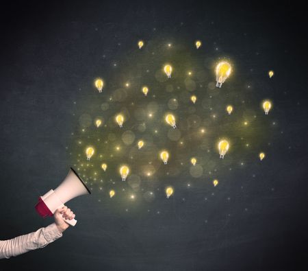 Caucasian business hand holding megaphone with yellow lightbulbs