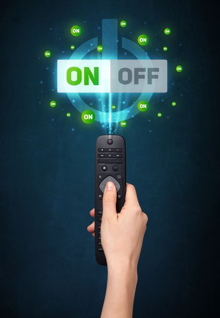 Hand holding a remote control, on-off signal coming out of it
