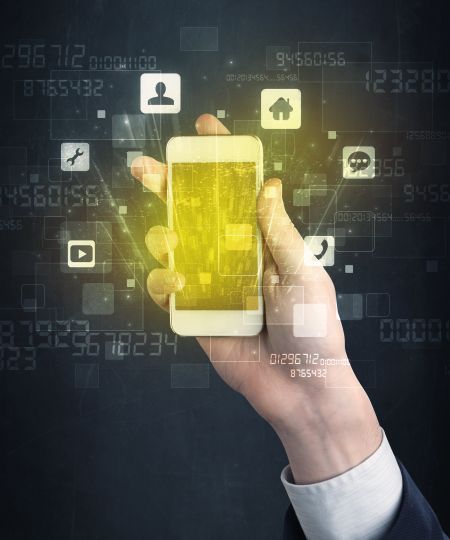 Caucasian hand in business suit holding a smartphone with golden-yellow holographic screen