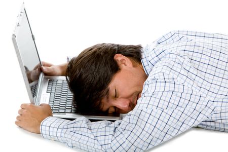 Tired business man sleeping in front of the computer isolated on white