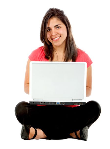 Girl sitting on the floor with a computer isolated on white
