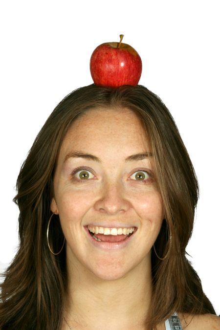 beautiful girl smiling with an apple on her head