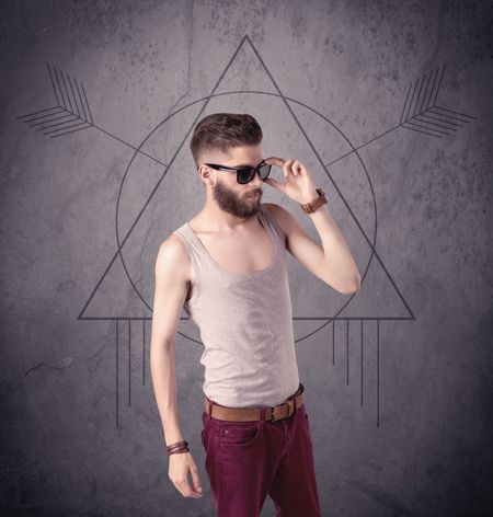 A young hipster male in modern clothes standing in front of an urban wall with modern sign illustration concept