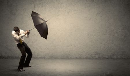 Handsome business man holding umbrella with copy space background concept