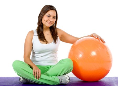 Fitness woman  with a pilates ball isolated over a white background