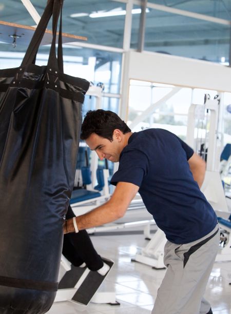 Handsome man exercising at the gym boxing