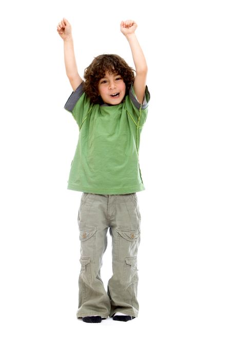 Excited little boy with arms up isolated over a white background