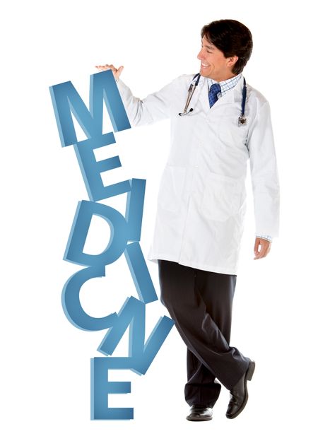 Male doctor leaning on the word medicine - isolated
