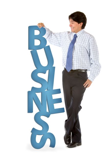 Corporate man leaning on the word business - isolated on white