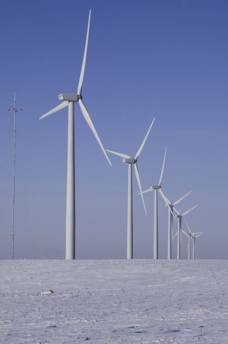 Row of wind turbines, part of windfarm in rural Illinois, in winter