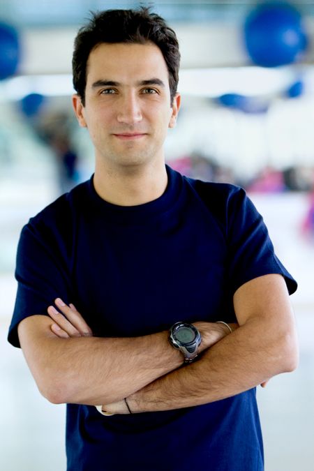 Confident handsome man portrait at the gym