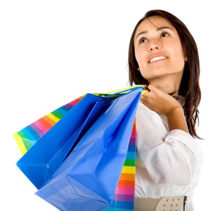 Pensive woman with shopping bags isolated over a white background