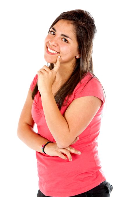 Pensive girl smiling isolated over a white background