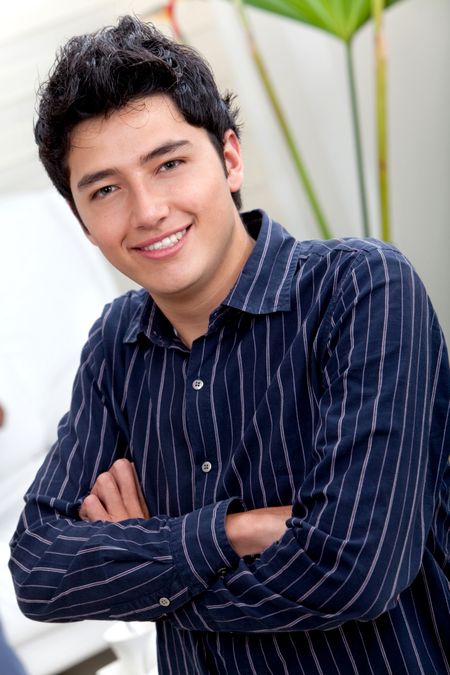 Handsome male portrait with arms crossed and smiling