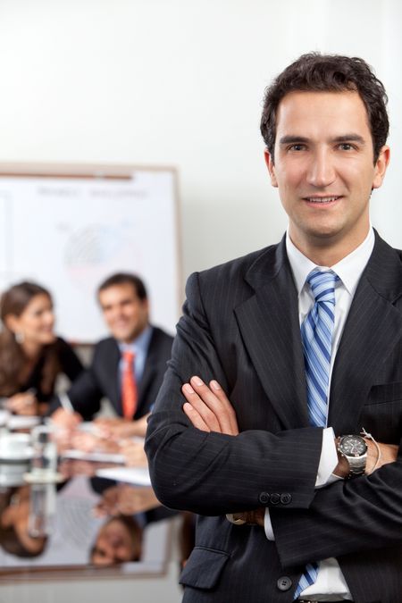 Confident business man at the office leading a group