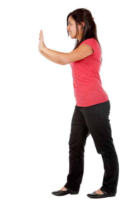 Woman pushing an imaginary object isolated over a white background