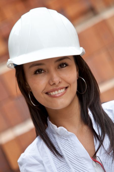 Female engineer at a construction site and smiling