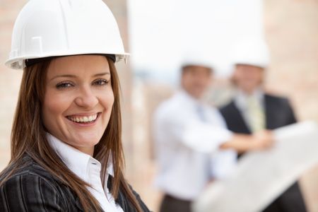 Female engineer at a construction site and smiling