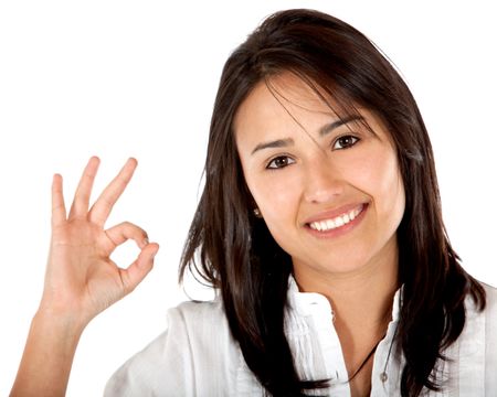 Girl making an ok sign isolated over a white background