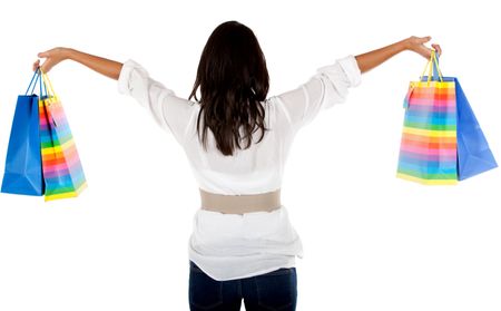 Woman holding some shopping bags isolated over a white background