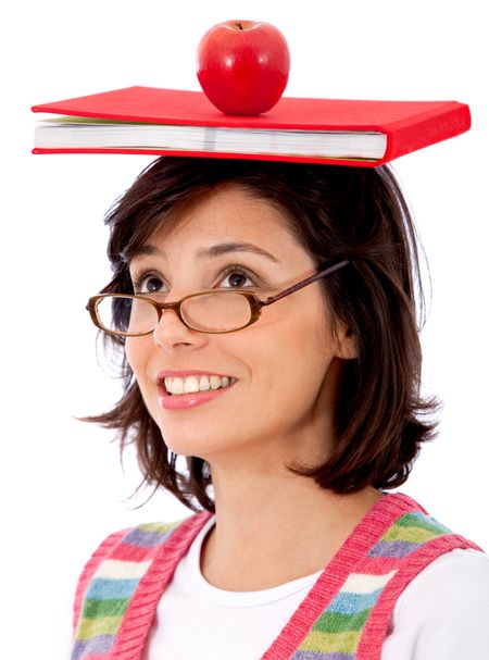 Student with book and an apple over her head isolated over a white background