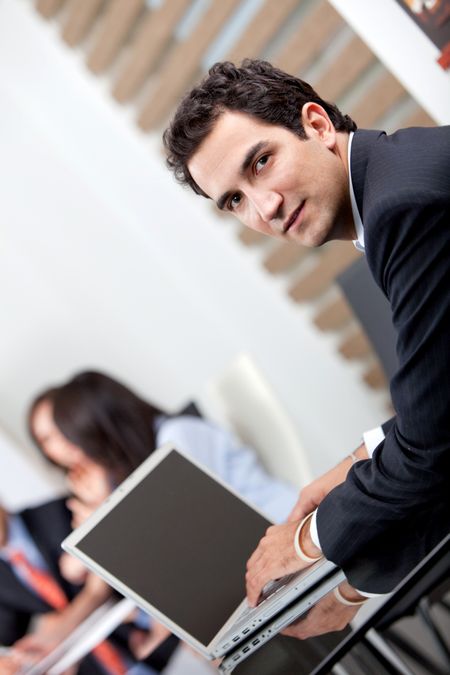 Business man at the office with a laptop