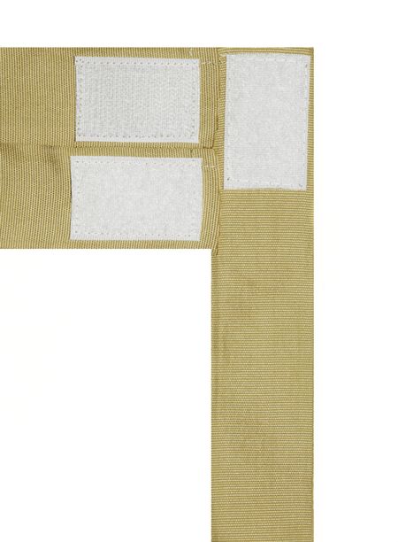 White velcro tabs on three tan strips of fabric isolated on white