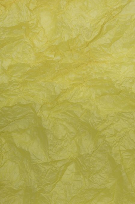 Texture of crinkled yellow wrapping paper