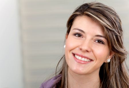 Portrait of a beautiful young woman indoors and smiling