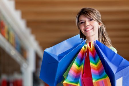 Woman holding some shopping bags and smiling