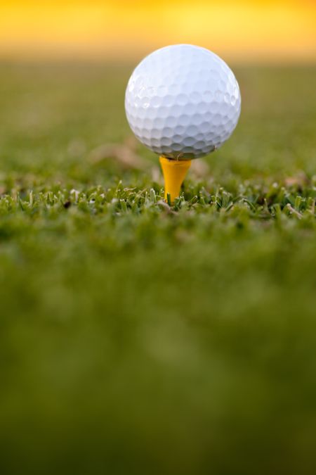 White golf ball lying over grass outdoors