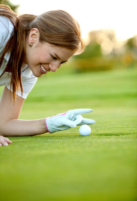 beautiful woman having fun on a golf course