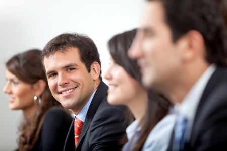 Friendly business man smiling in his office during a meeting