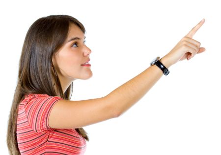 casual woman pointing something isolated over a white background