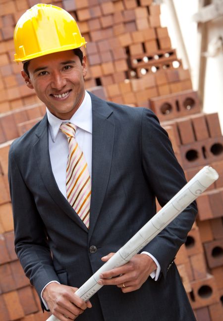 Elegant engineer holding a model in a construction