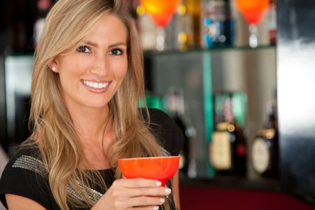 happy woman smiling in a bar or a nightclub